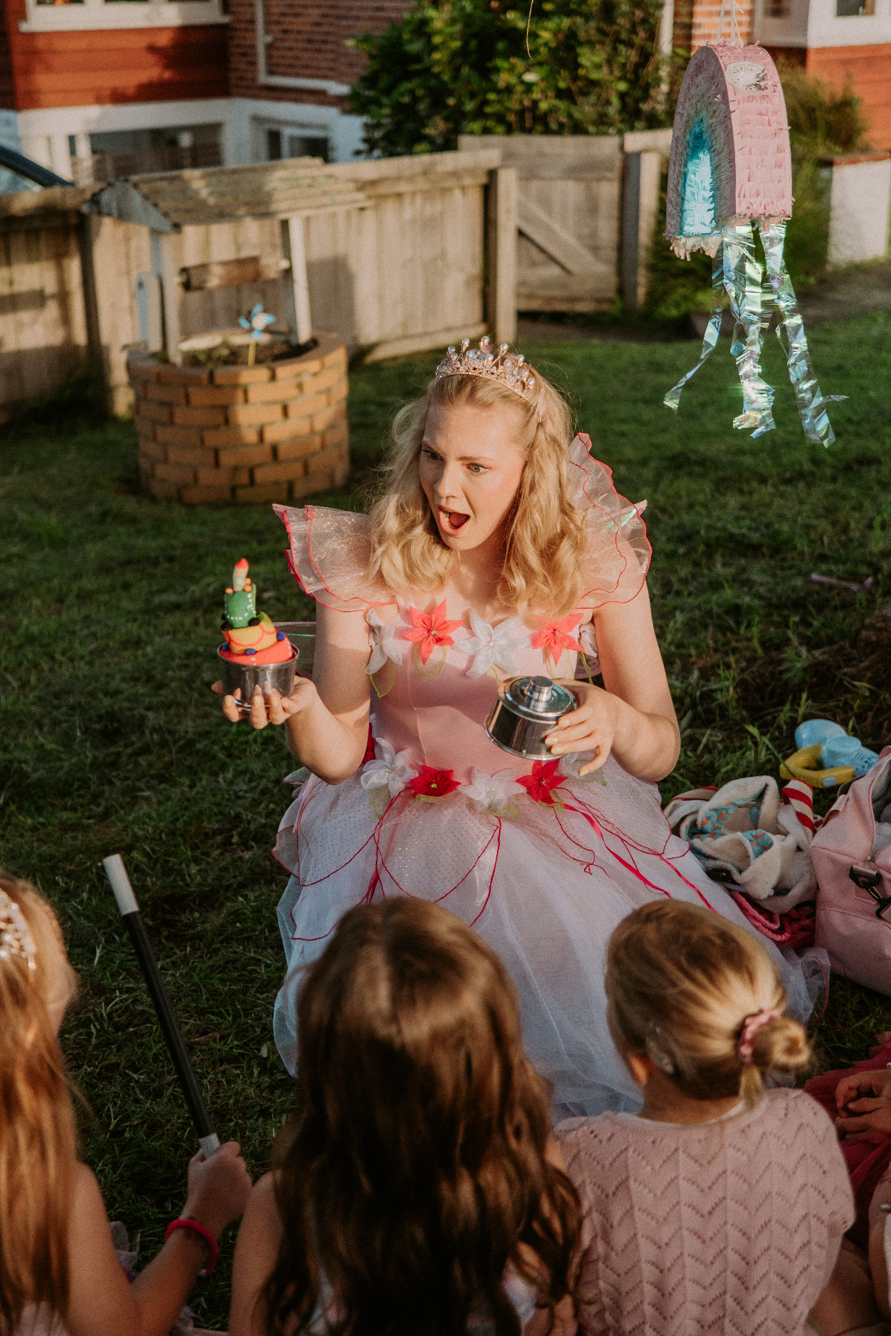 Zoe, kid's party entertainer, holding a pink balloon dog